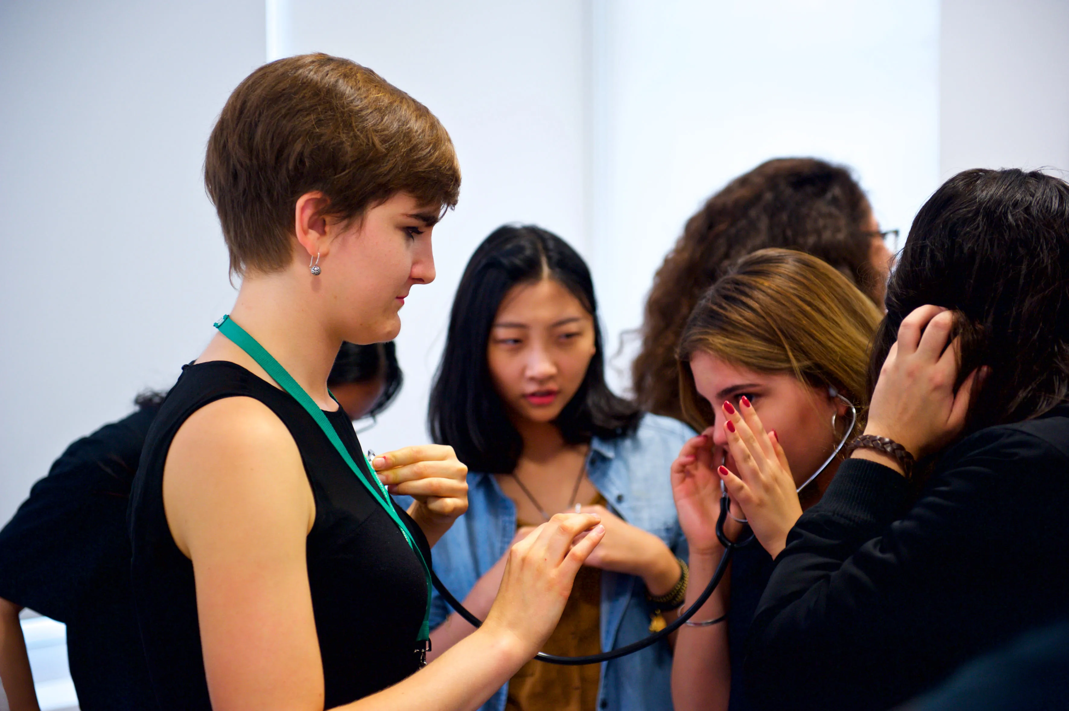 medical students listening for a heartbeat on fellow students