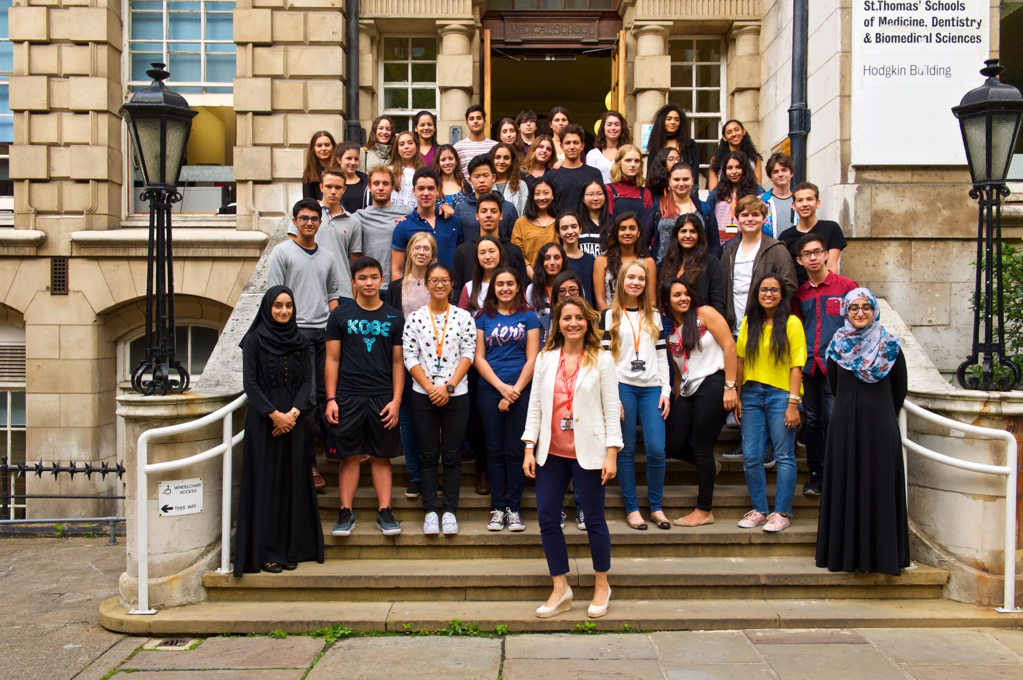 medical students and their lecturer gatheres on the steps of the Hodgkin Building, Guy's Campus, King's College London.