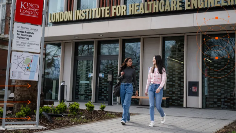 Two female students walking outside of the LIHE building