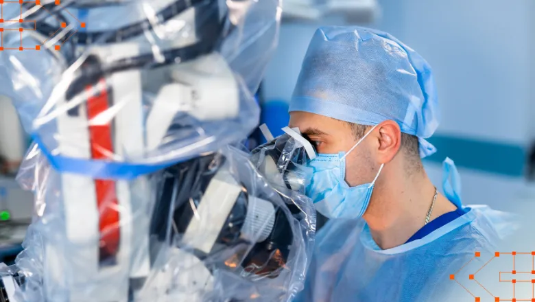 A clinician working with robotic medical equipment in a lab.