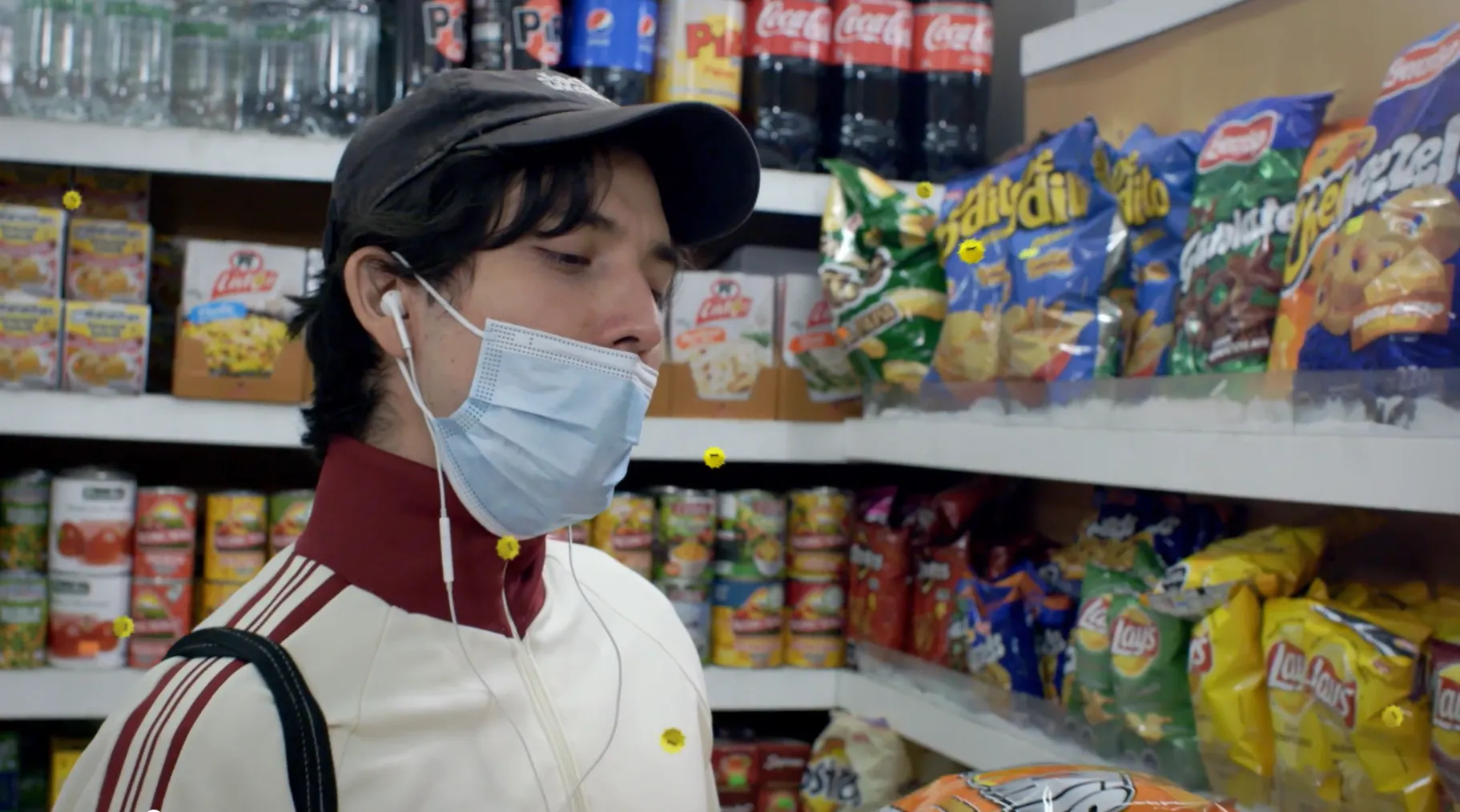 A man wears face covering incorrectly in a shop