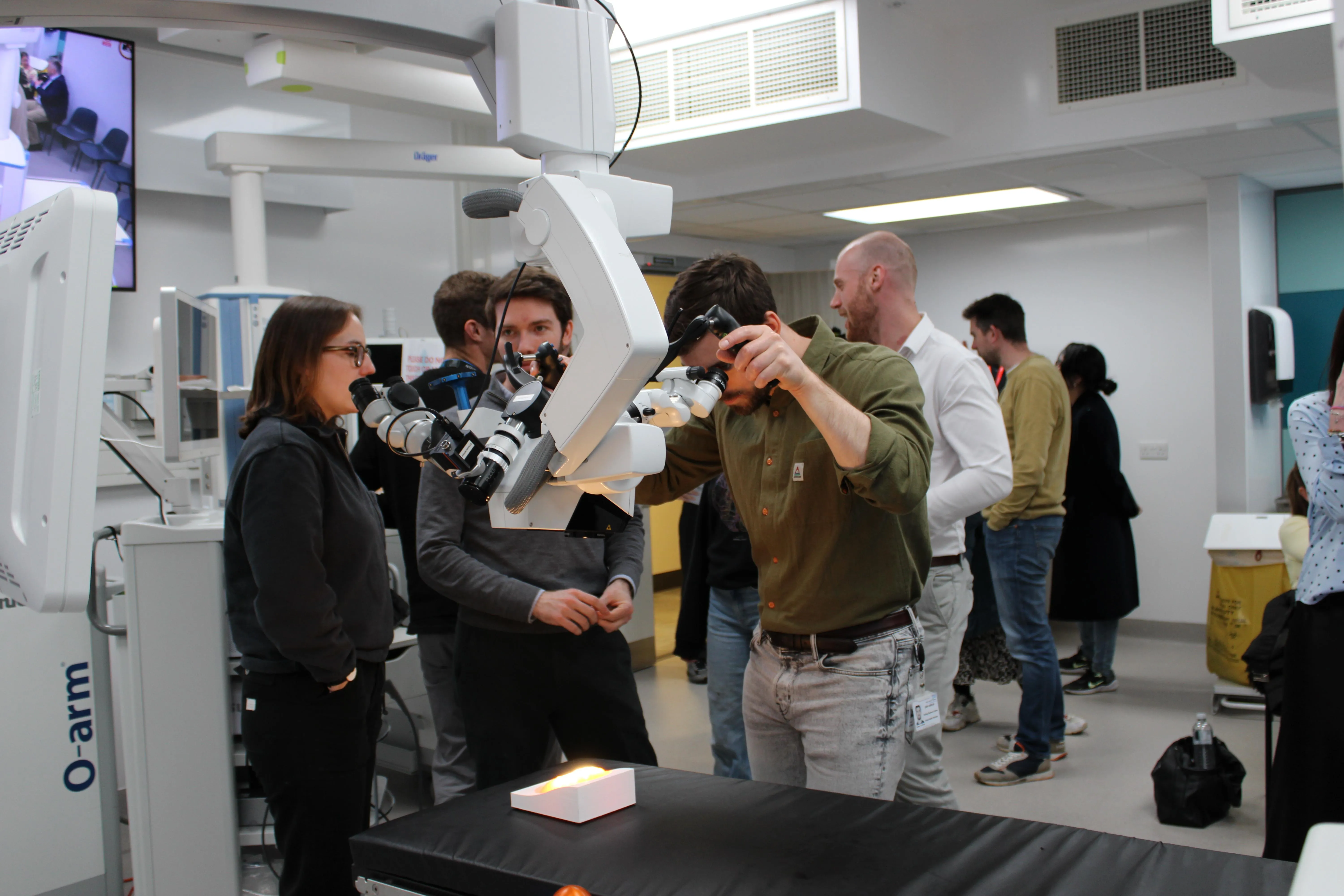 Man looking into surgical microscope