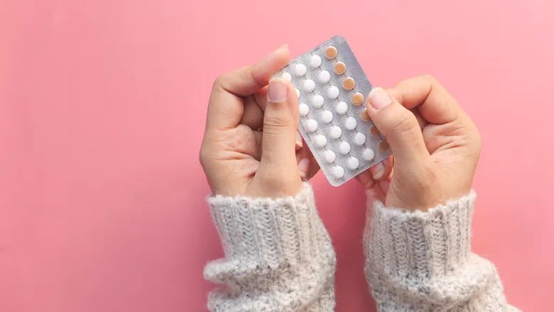 A pair of hands holding a blister pack of 30 tablets