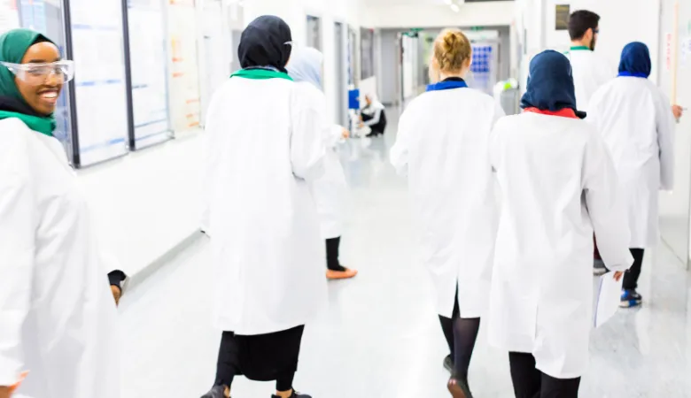 IPS students walking in labcoats