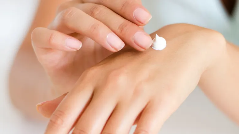 woman using lotion on hands 