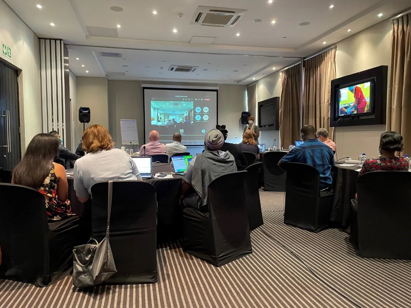 Participants look at a presentation at the COVAB consortium