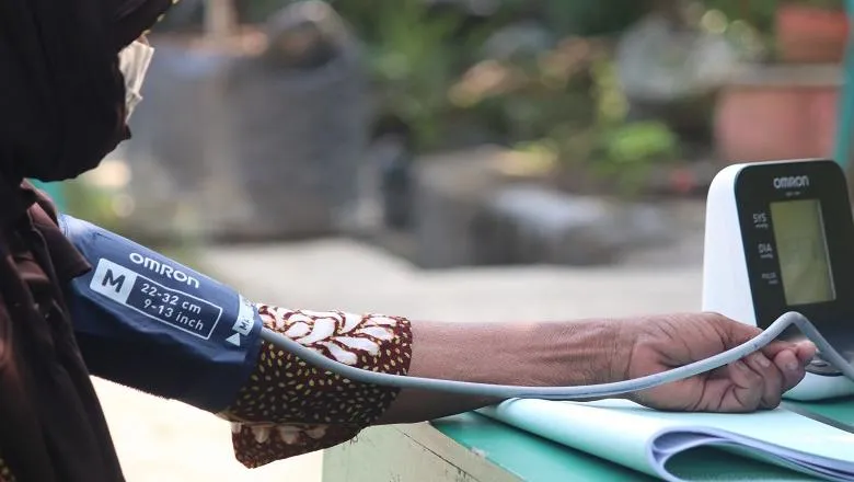 A woman getting her blood pressure tested