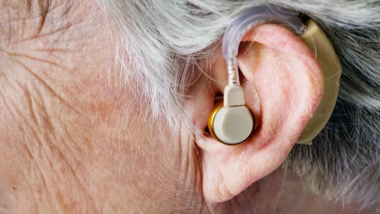 An elderly woman wearing a hearing aid