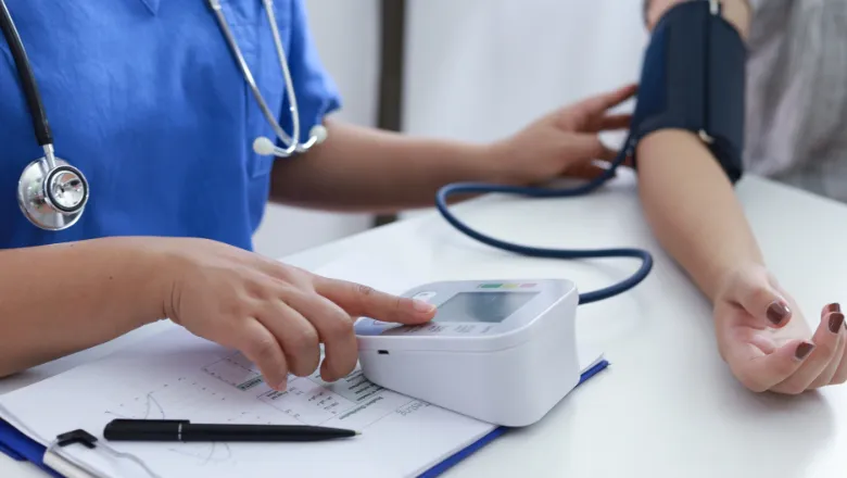 A healthcare professional checks a patient's blood pressure