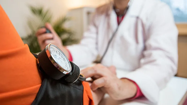 doctor checking blood pressure