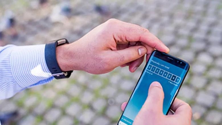 Hands holding a smartphone taking part in a survey