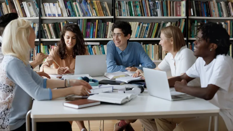 Young researchers sitting around a table at university