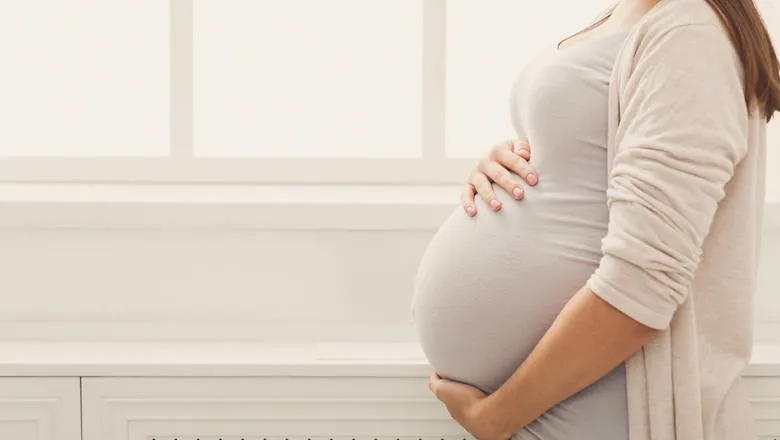 Pregnant woman holding her belly