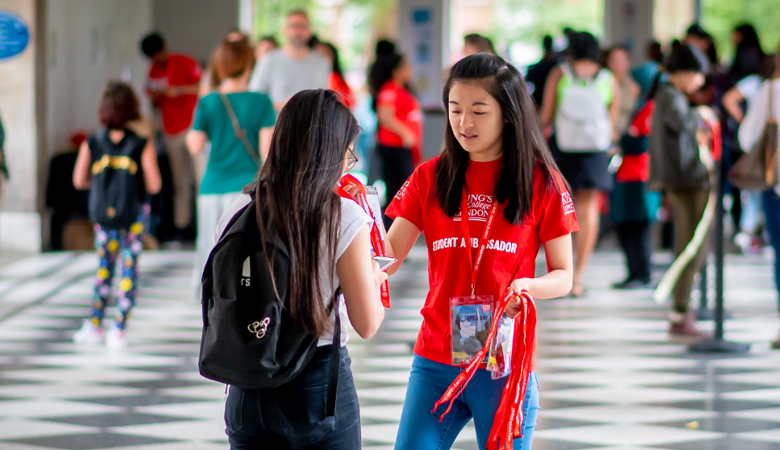 two students talking at an open day
