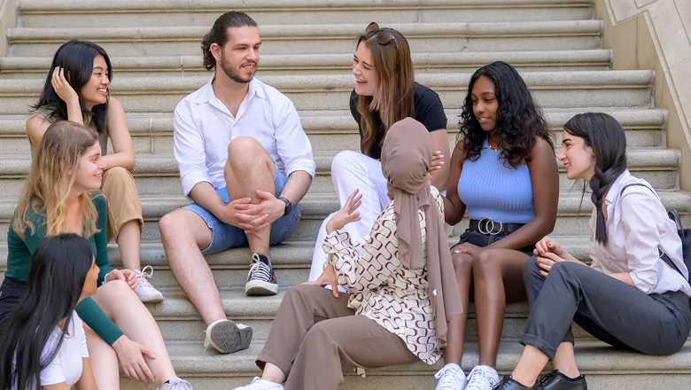 A group of Kings students sitting on the steps of the Bush House quad 