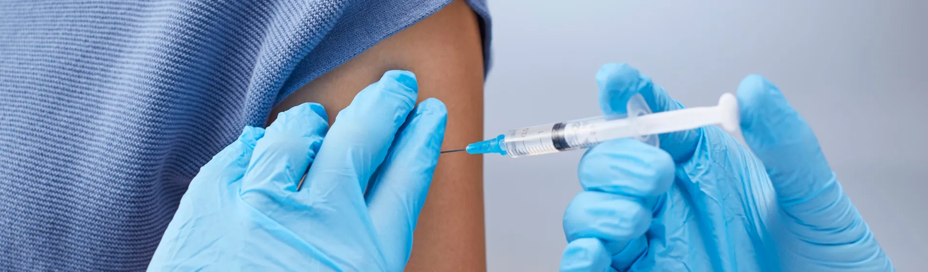 A person having a injection into their arm