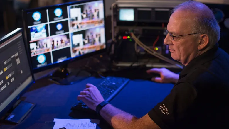 Man sitting in front of computer monitors