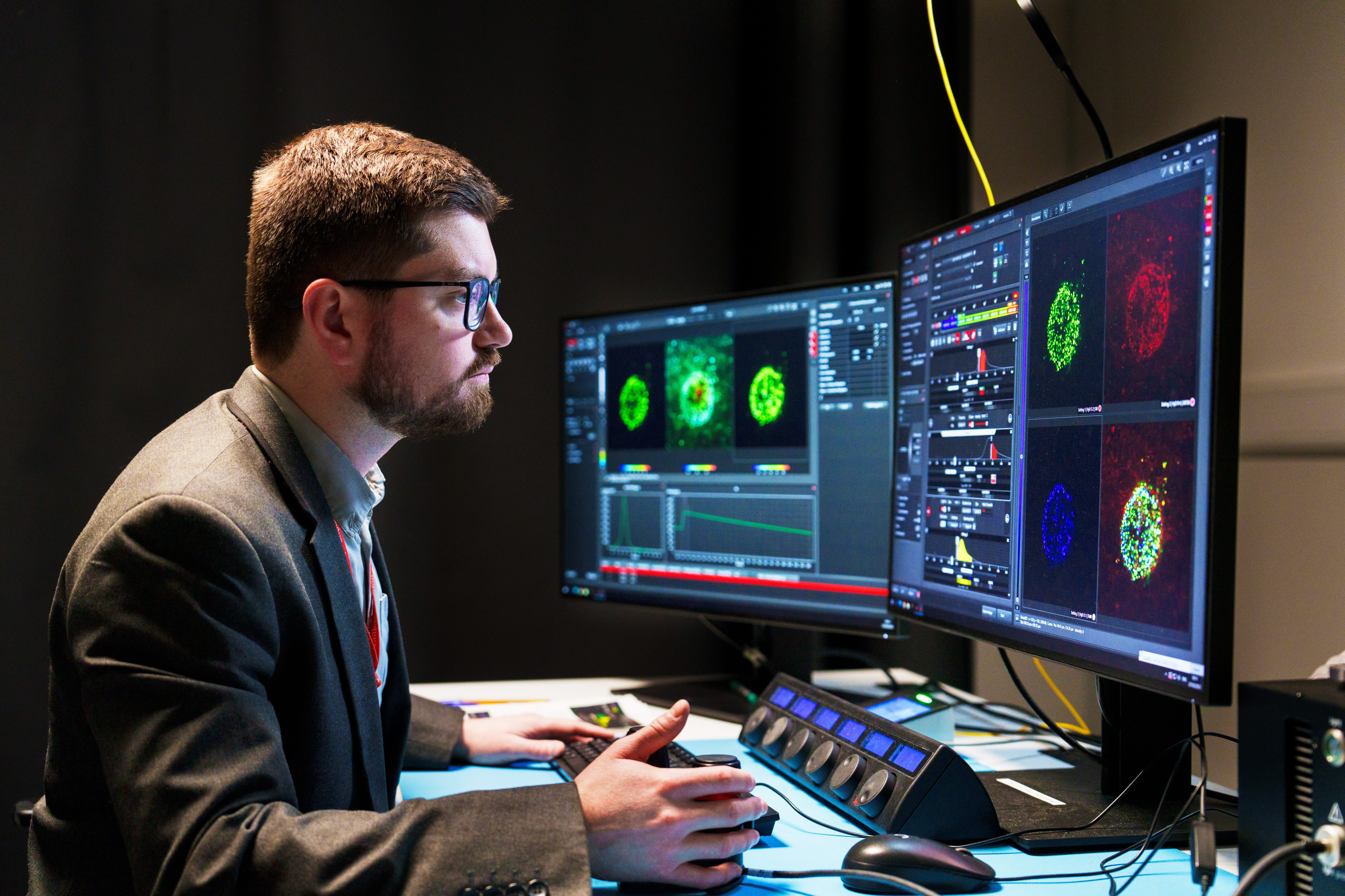 Man looking at a microscope computer screen