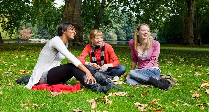Students in a park, laughing