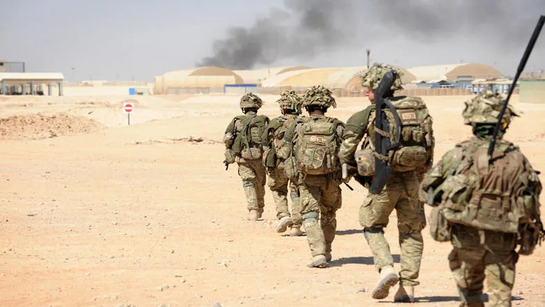 Soldiers walking through the desert