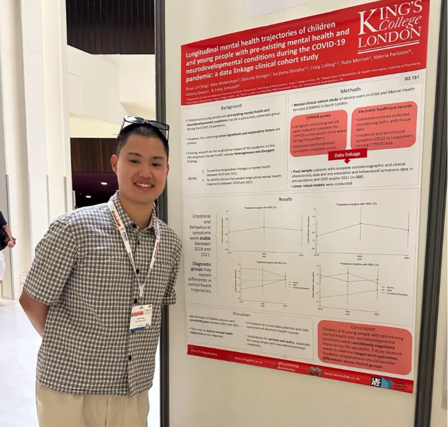 Researcher standing beside a King’s College London poster on youth mental health trajectories during COVID-19