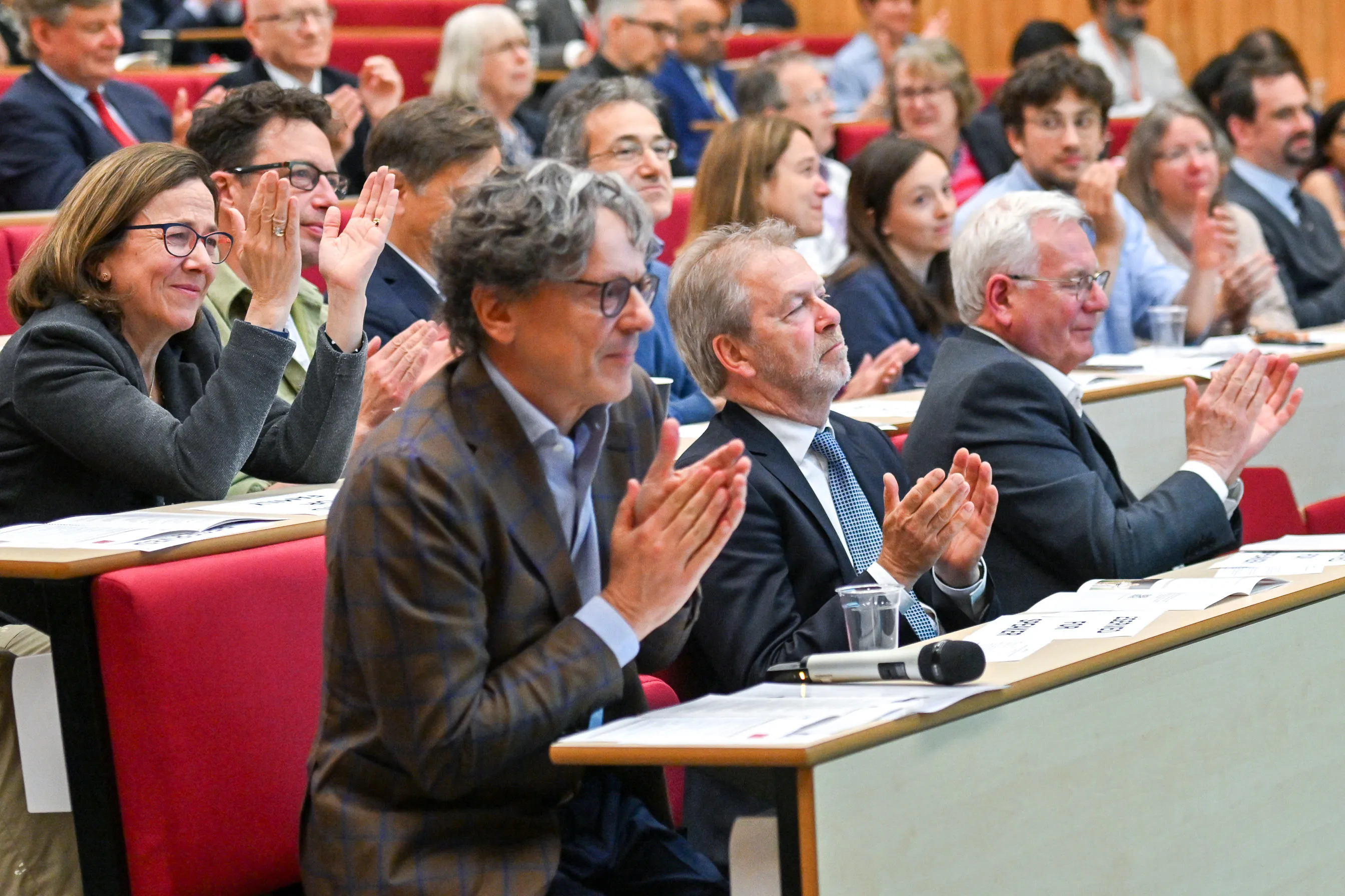a full lecture theatre with people clapping