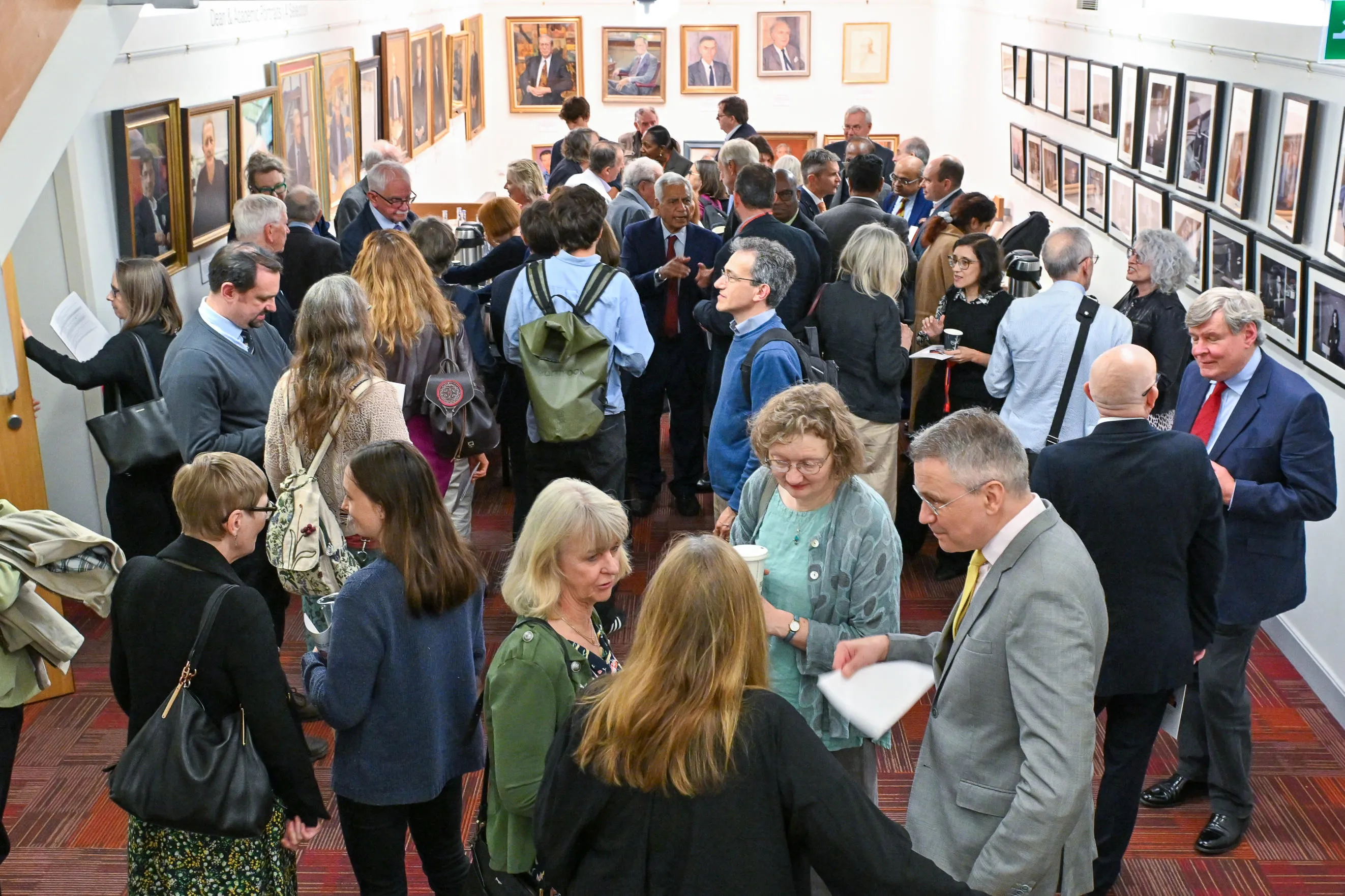 A group of people chatting and enjoying hot drinks at networking on arrival