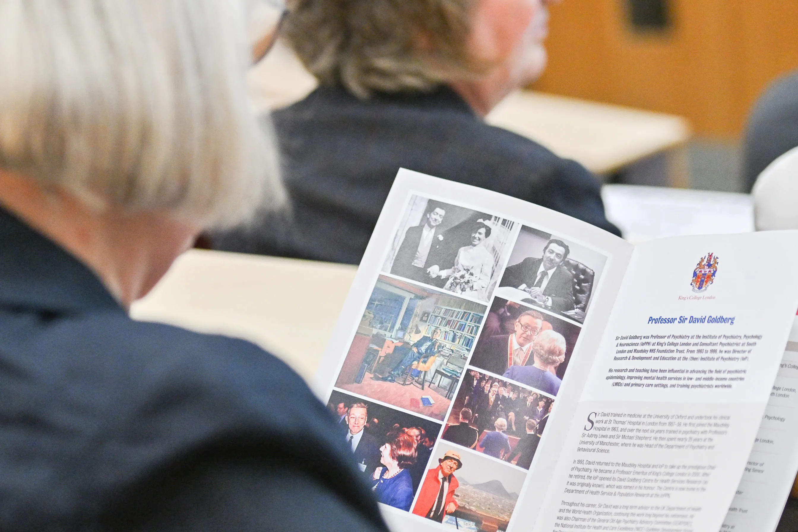photo taken over someones shoulder as they read the David Goldberg commemorative event programme