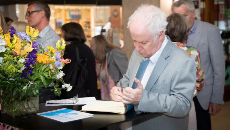 Pictured: Professor Sir Simon Wessely, Interim Executive Dean at the IoPPN, signs the memorial book.