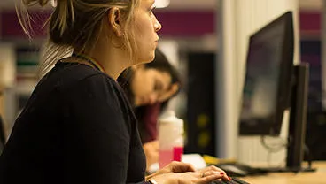 woman in a classroom at a desk