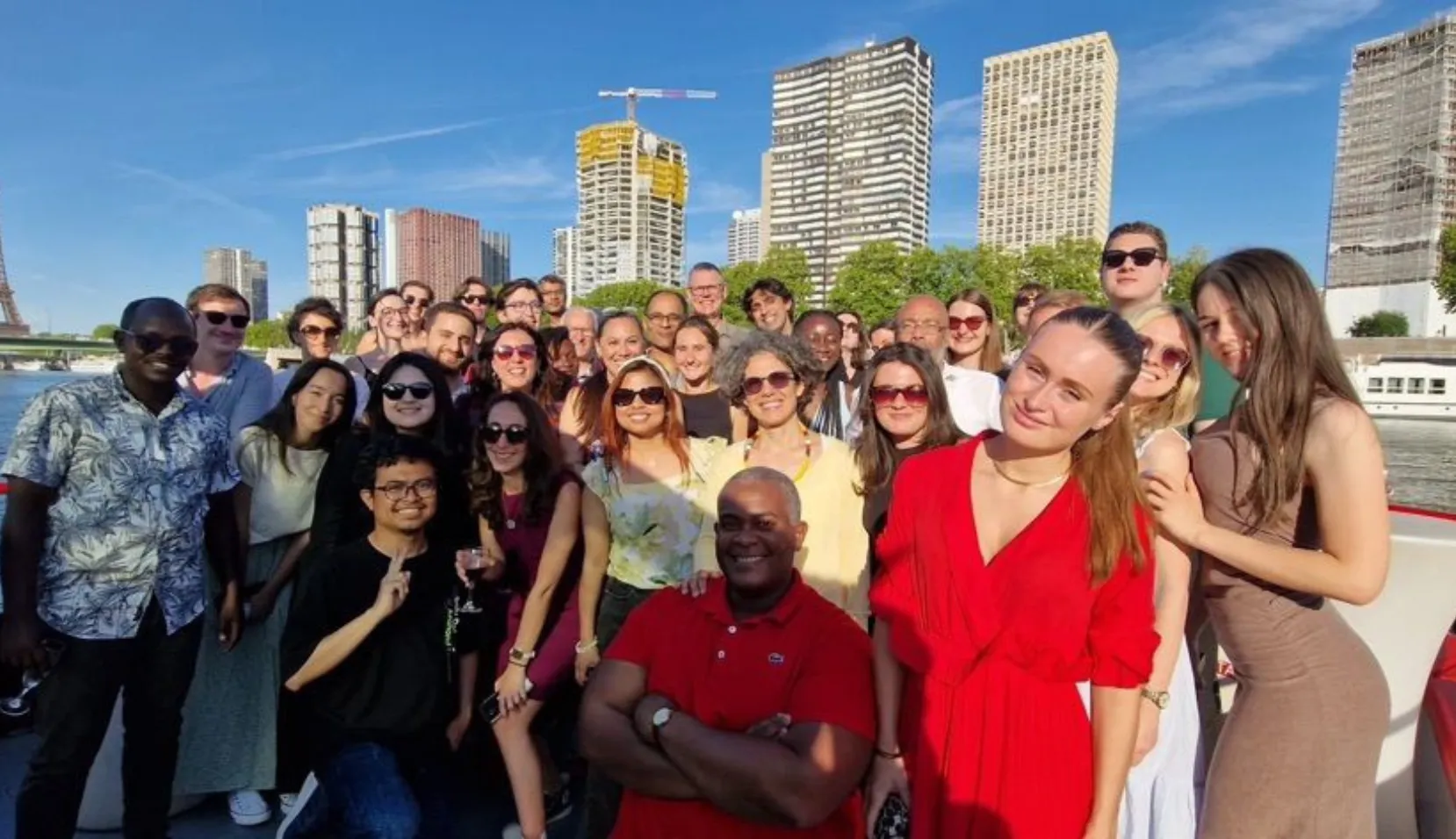 Group of people smiling at the camera on a boat