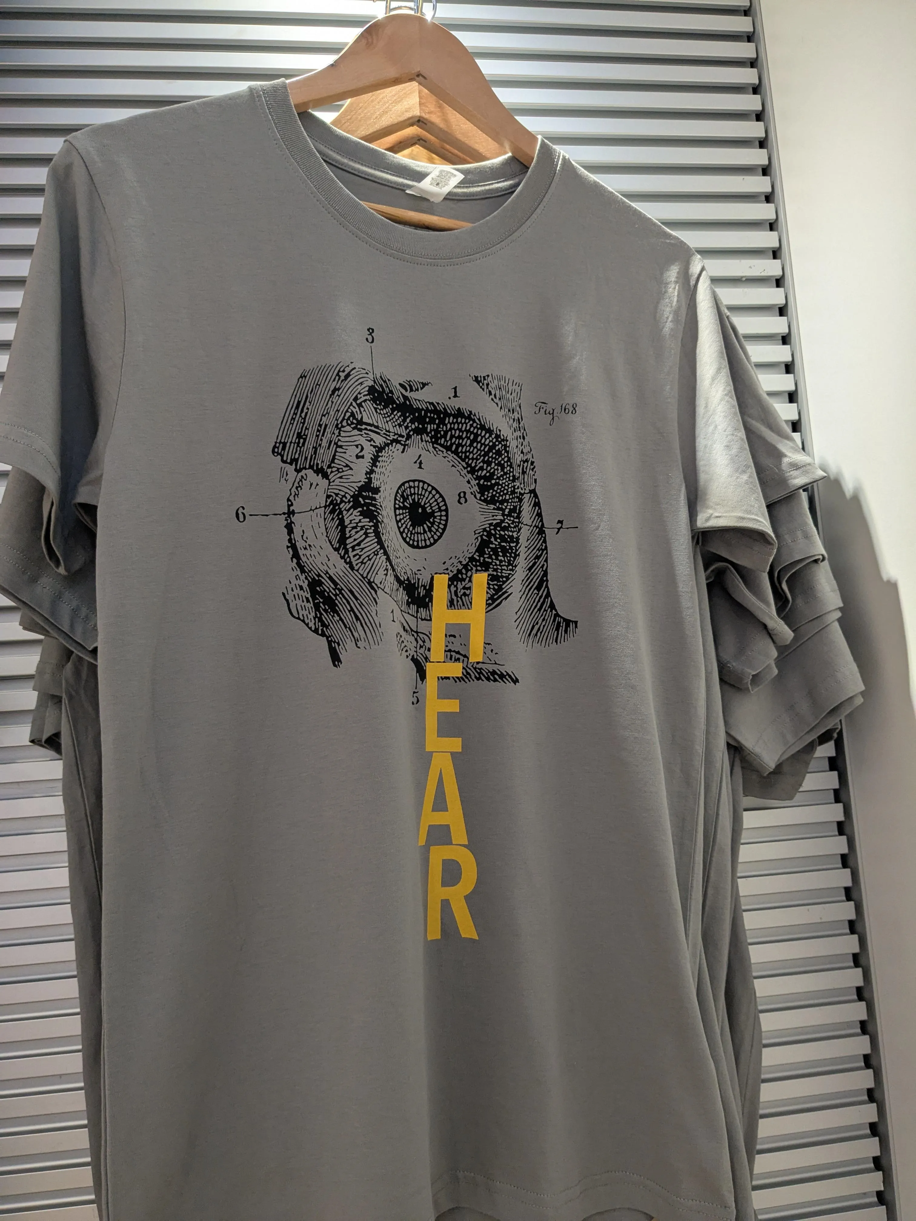 Grey t-shirt with image of eyeball and text 