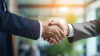 Two men in suits shaking hands