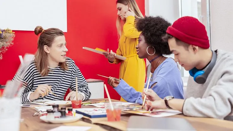 Group of people chatting and making art