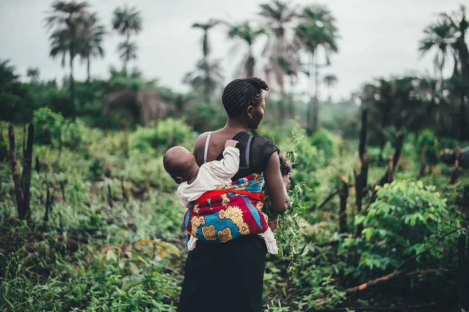 Woman with a baby strapped to her back in Africa