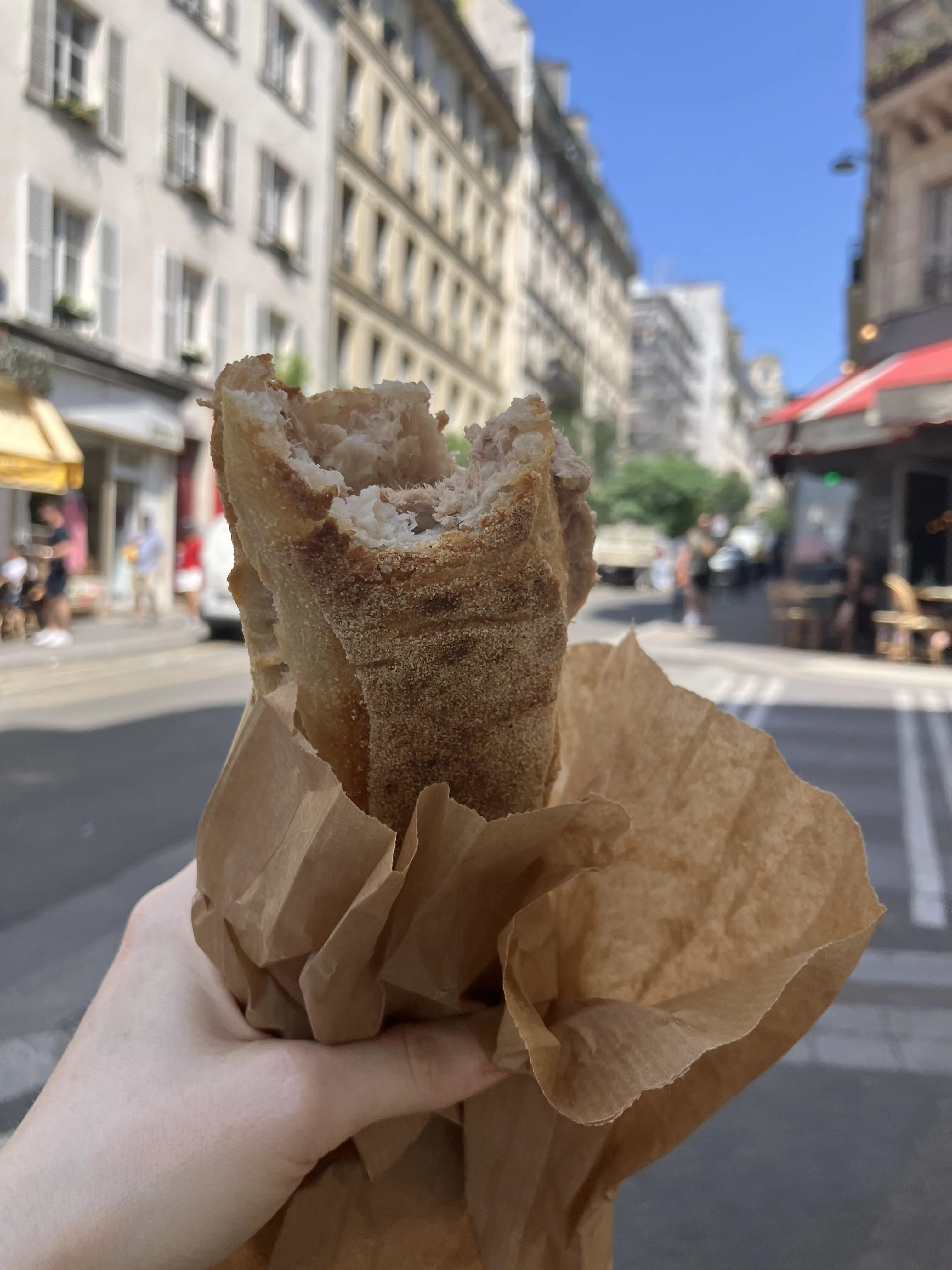 Person Holding Partially Eaten Baguette