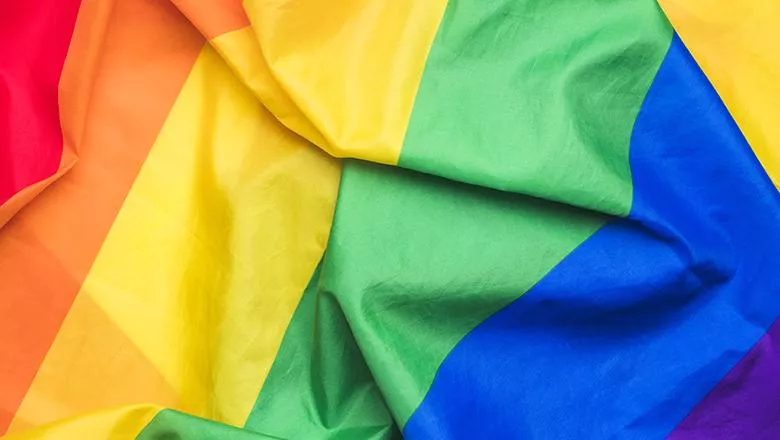 A closeup of a rainbow flag.