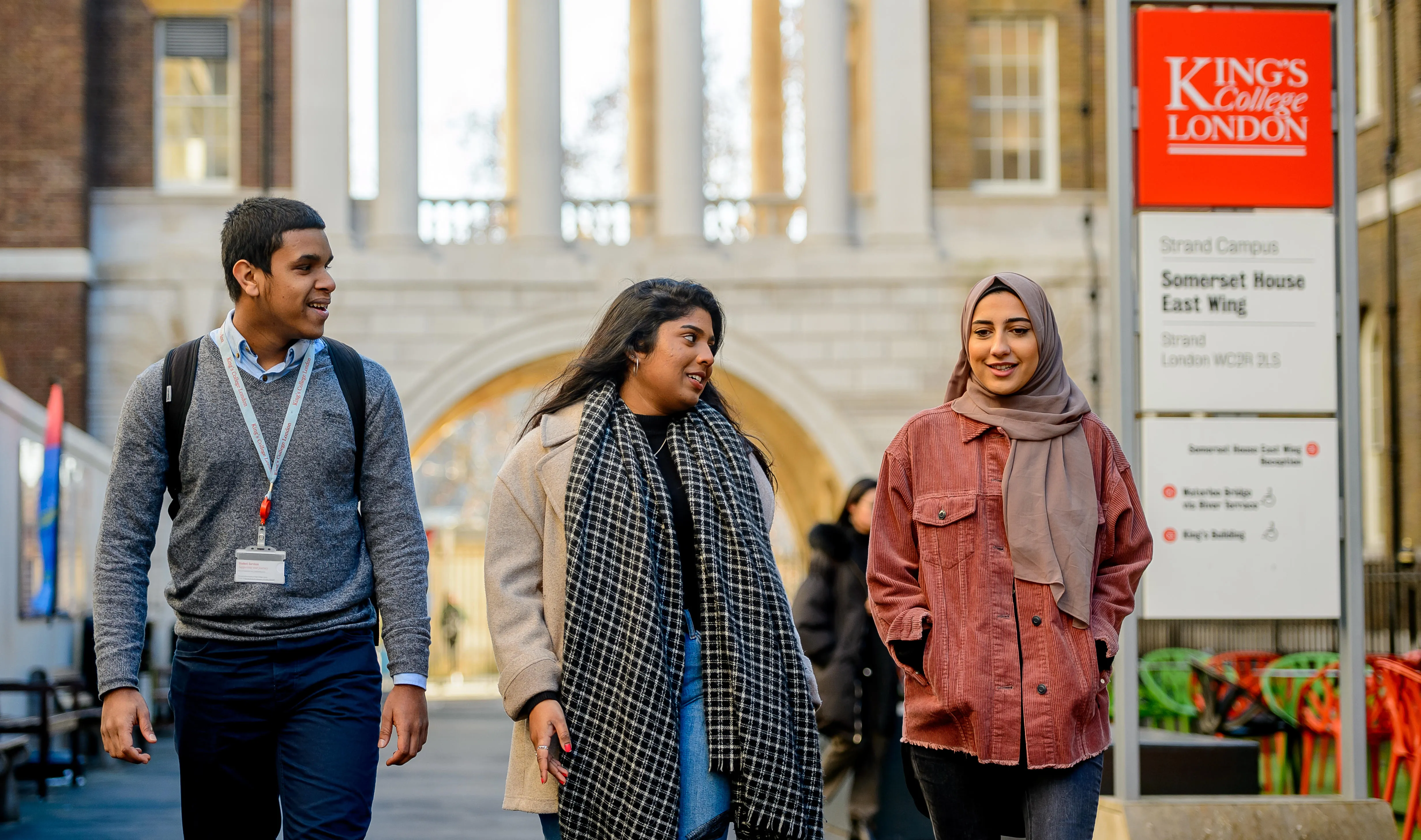 Three King's students walking together through Strand campus