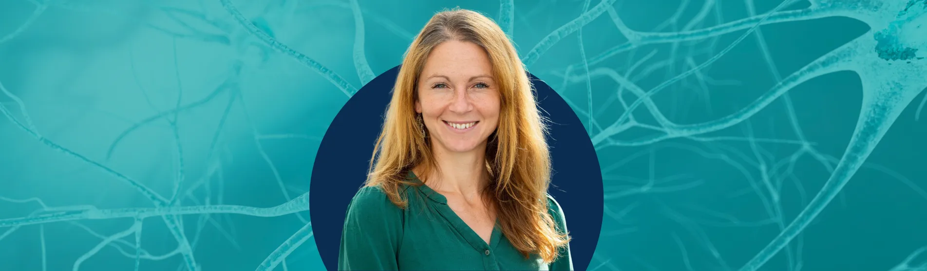 Woman smiling in front of blue background