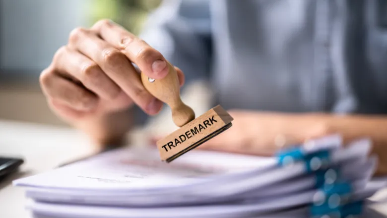 A person about to stamp some papers with a trade mark stamp