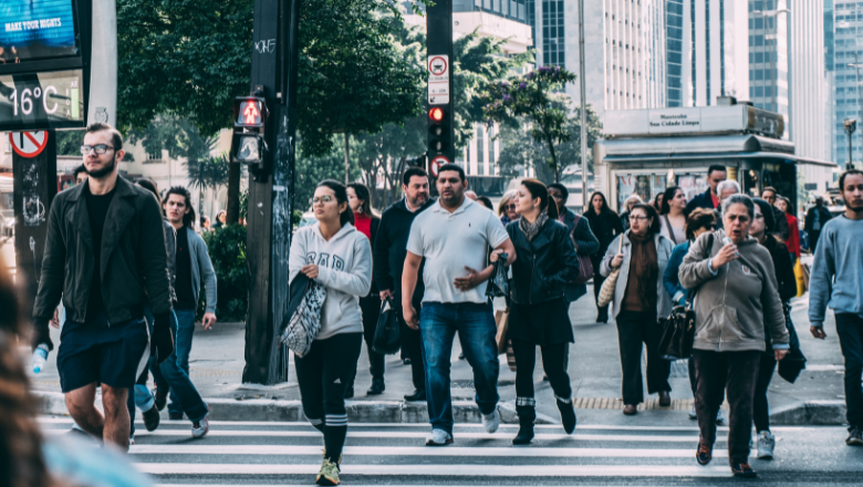People walking across a busy crosswalk