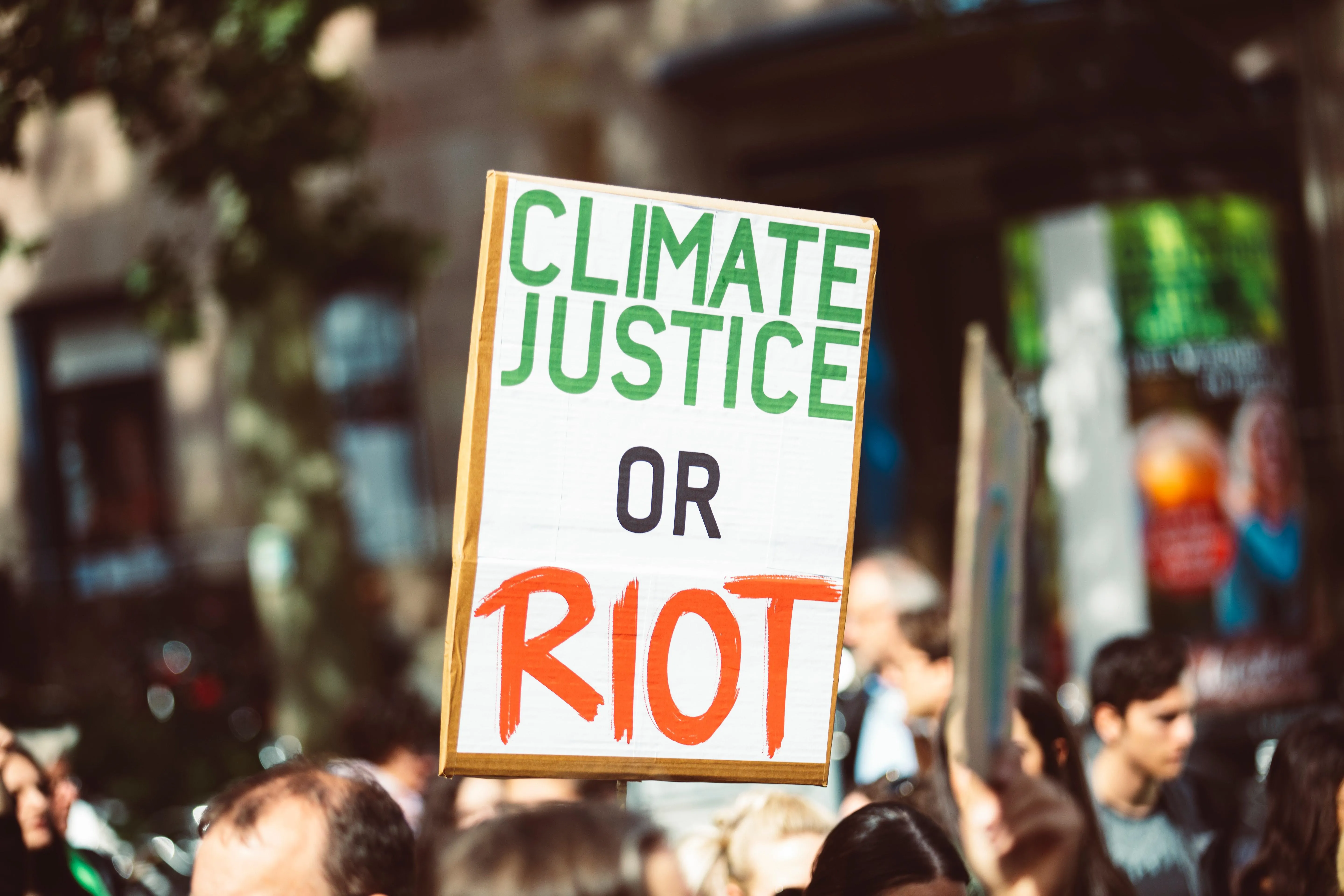 climate justice poster saying: climate justice or riot