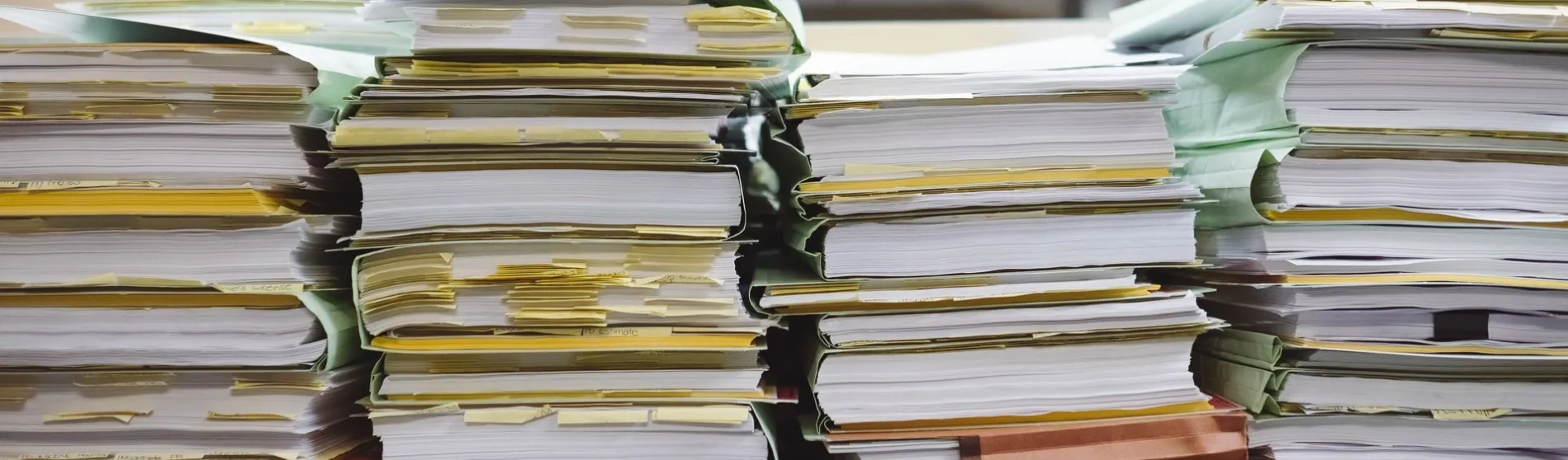 Stacks of paper files viewed from the side