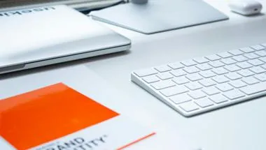 a keyboard and book on brand identity