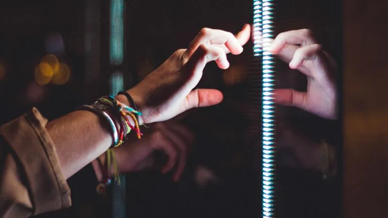 a hand touching a screen with code on