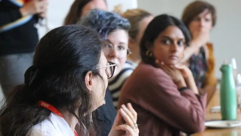 Participants listening to someone speak in a seminar