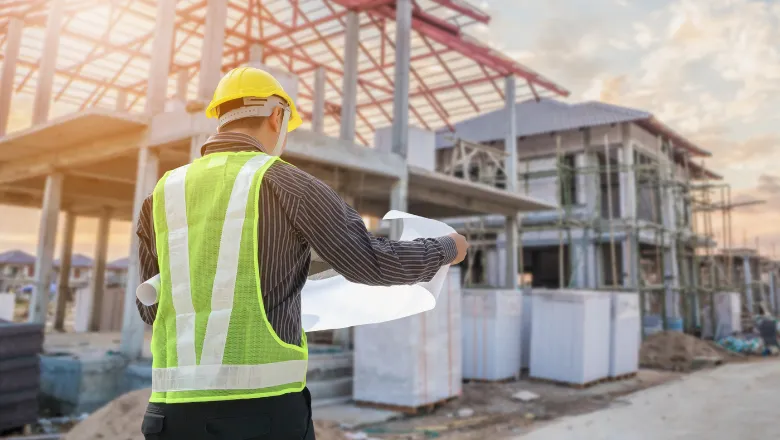 Building site with man reading plans