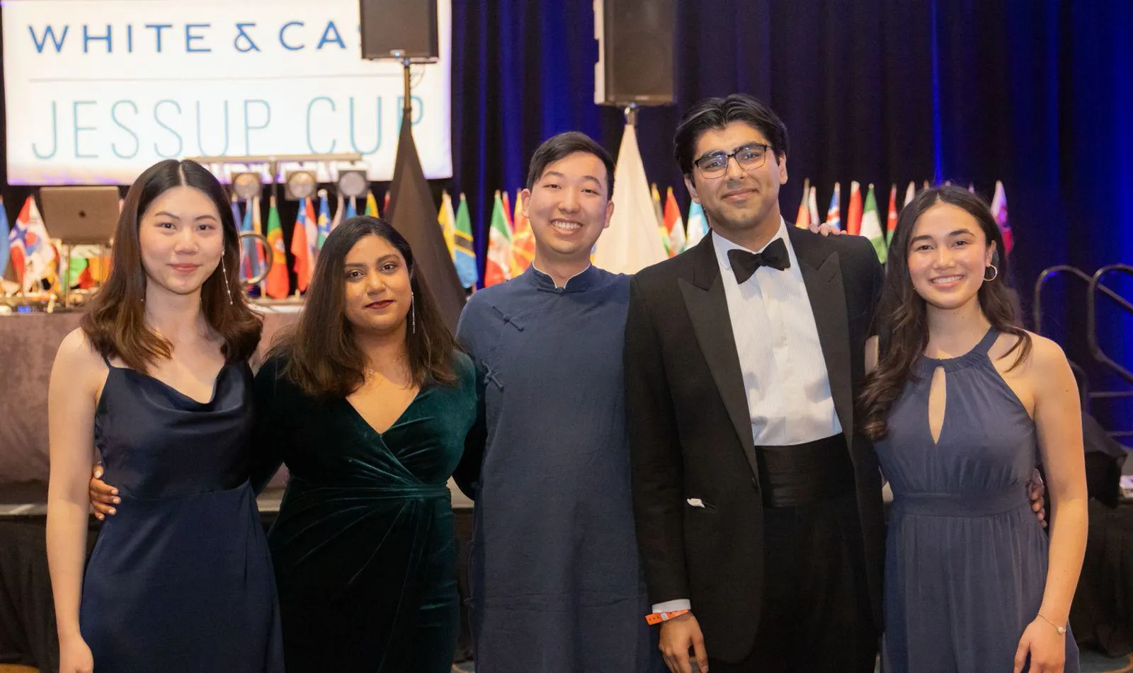 Five members of the mooting team in a group picture with smiles on their faces.