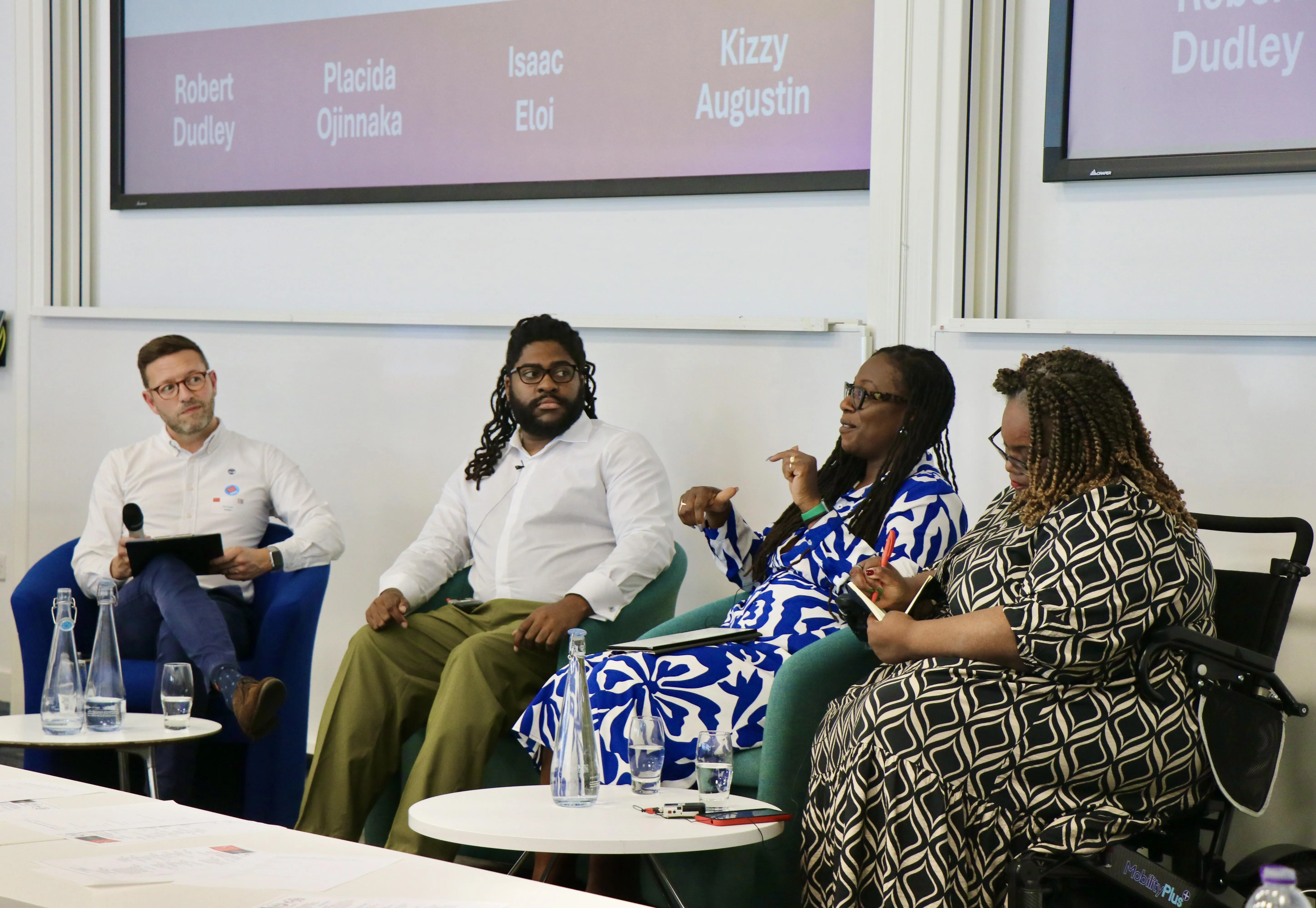 Four panel members engaged in a discussion. They are: Placida Ojinnaka, Isaac Eloi, Kizzy Augustin and Robert Dudley