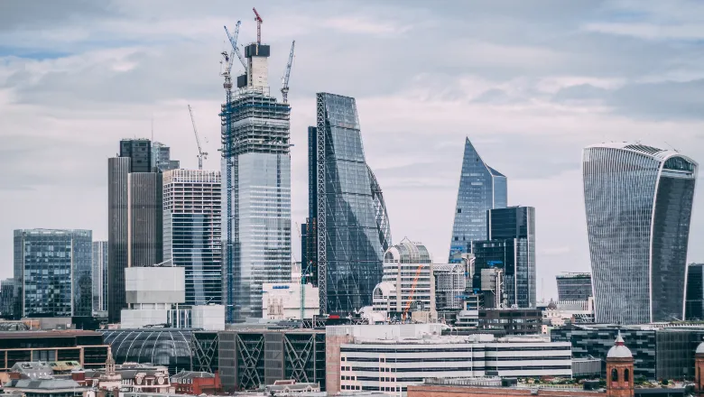 London skyline in the foreground, with cloudy sky in the background